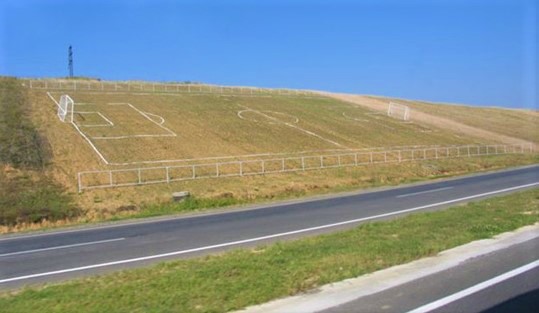 A football pitch at an angle on the side of a hill